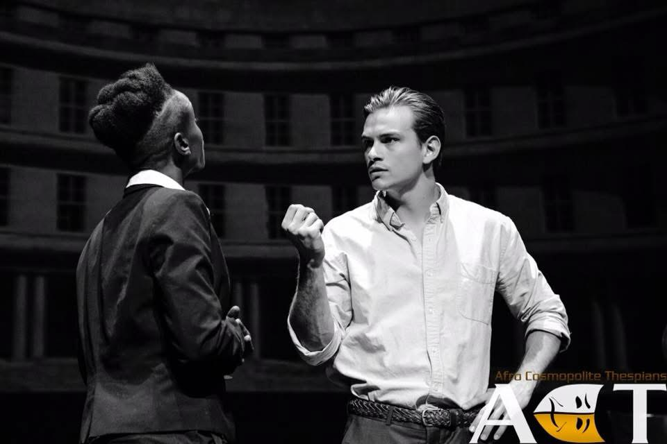 Antonio confronting Shylock in a black-and-white stage still from The Merchant of Venice.